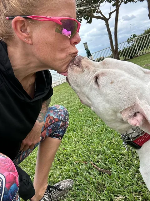 Jenn getting a kiss from a client